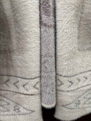 A cream-colored fuzzy knit hooded sweater with a brown horse graphic and geometric patterns. 