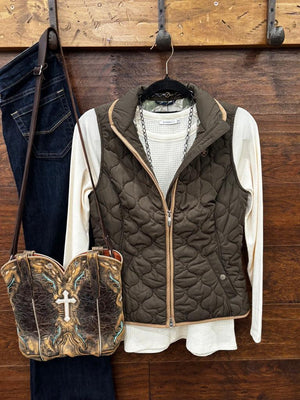 An earth tome quilted zip-up vest layered over a cream knit sweater