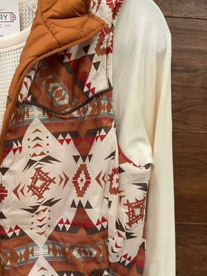  Reversible vest, featuring a striking Aztec print on one side and a solid camel finish on the reverse. 