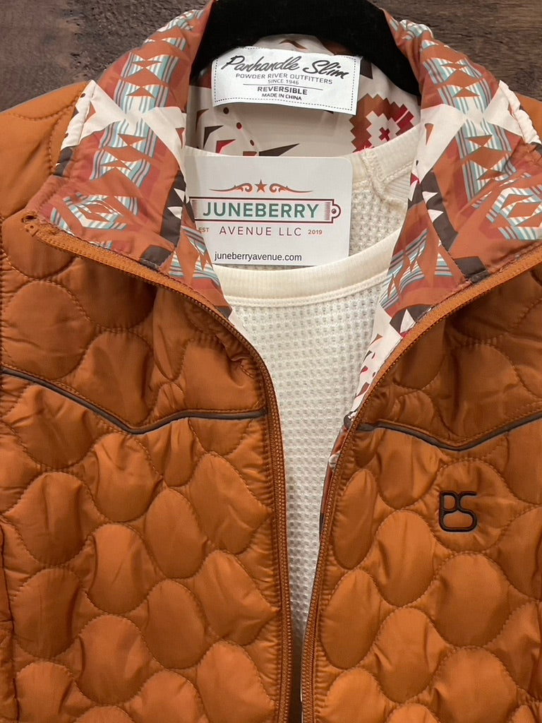  Reversible vest, featuring a striking Aztec print on one side and a solid camel finish on the reverse. 
