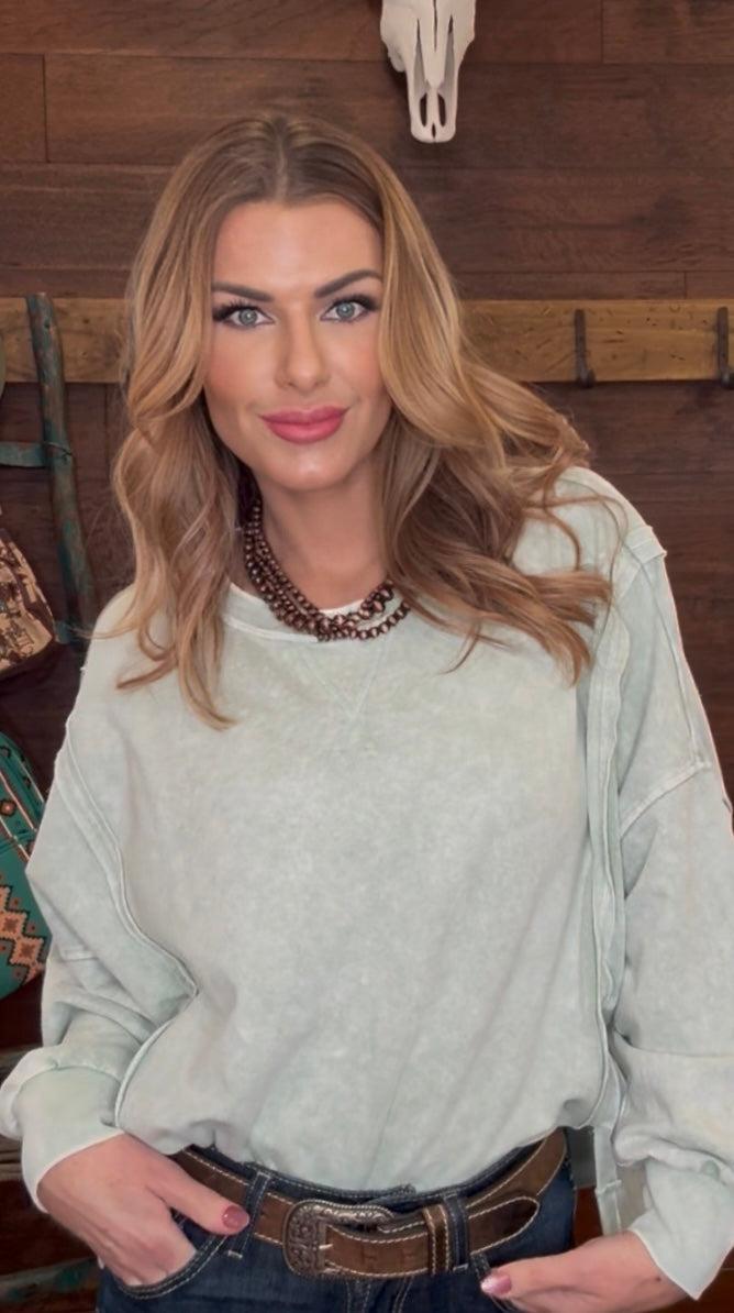 Woman wearing a mint green sweater 