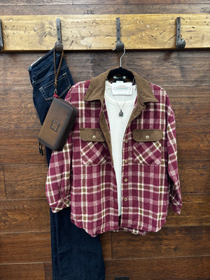 A burgundy and beige plaid flannel shirt with a brown corduroy collar and chest pockets
