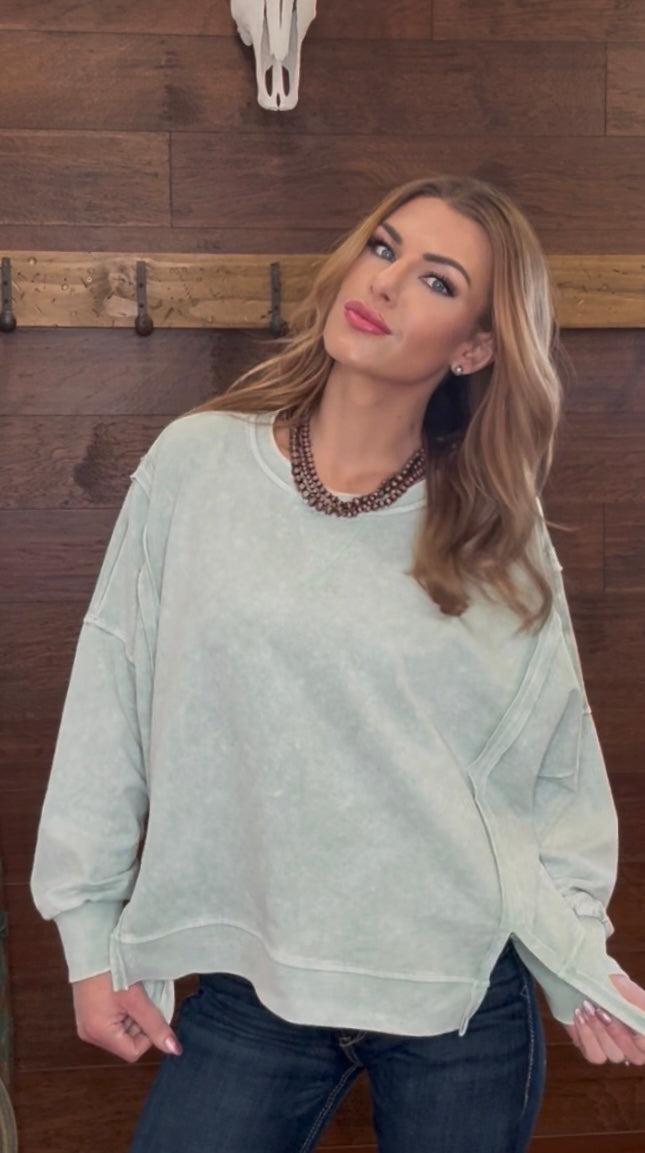 Woman wearing a mint green sweater 
