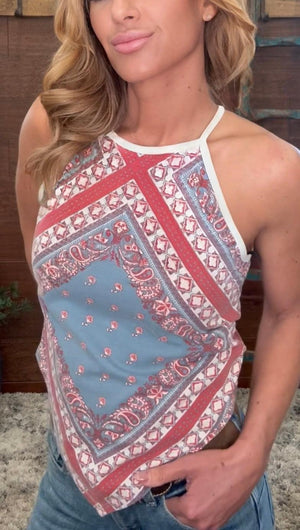 Woman wearing a patterned tank top with a blurred background
