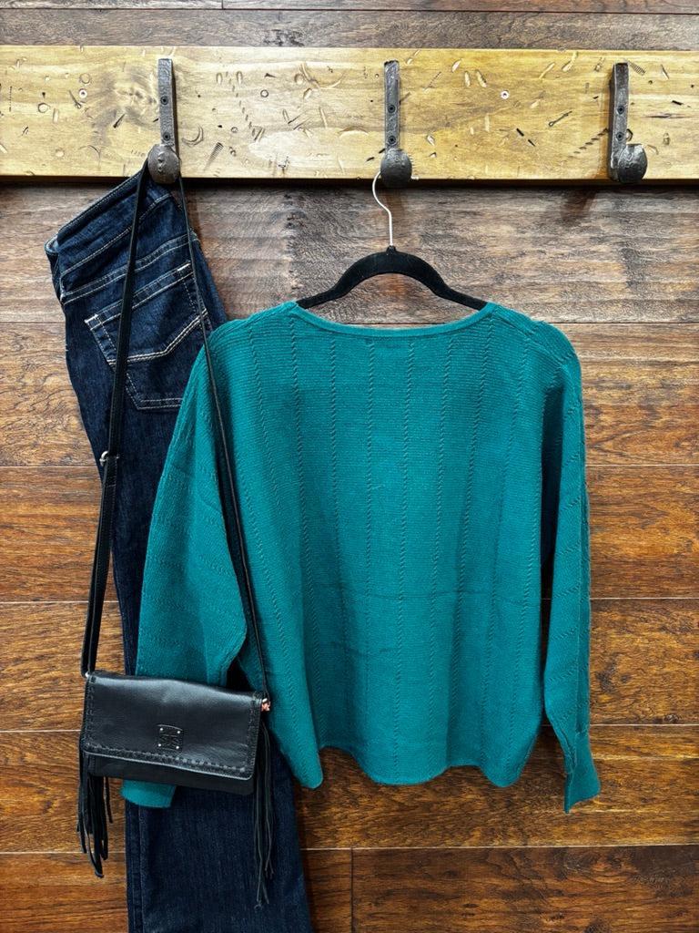 This sweater features a refined vertical texture, long dolman sleeves, and a classic boat neckline 