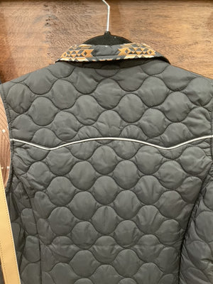 A black quilted zip-front vest with decorative tan and black geometric embroidery on the collar