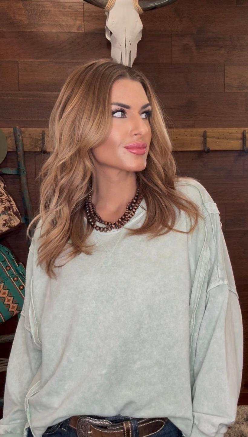 Woman wearing a mint green sweater 