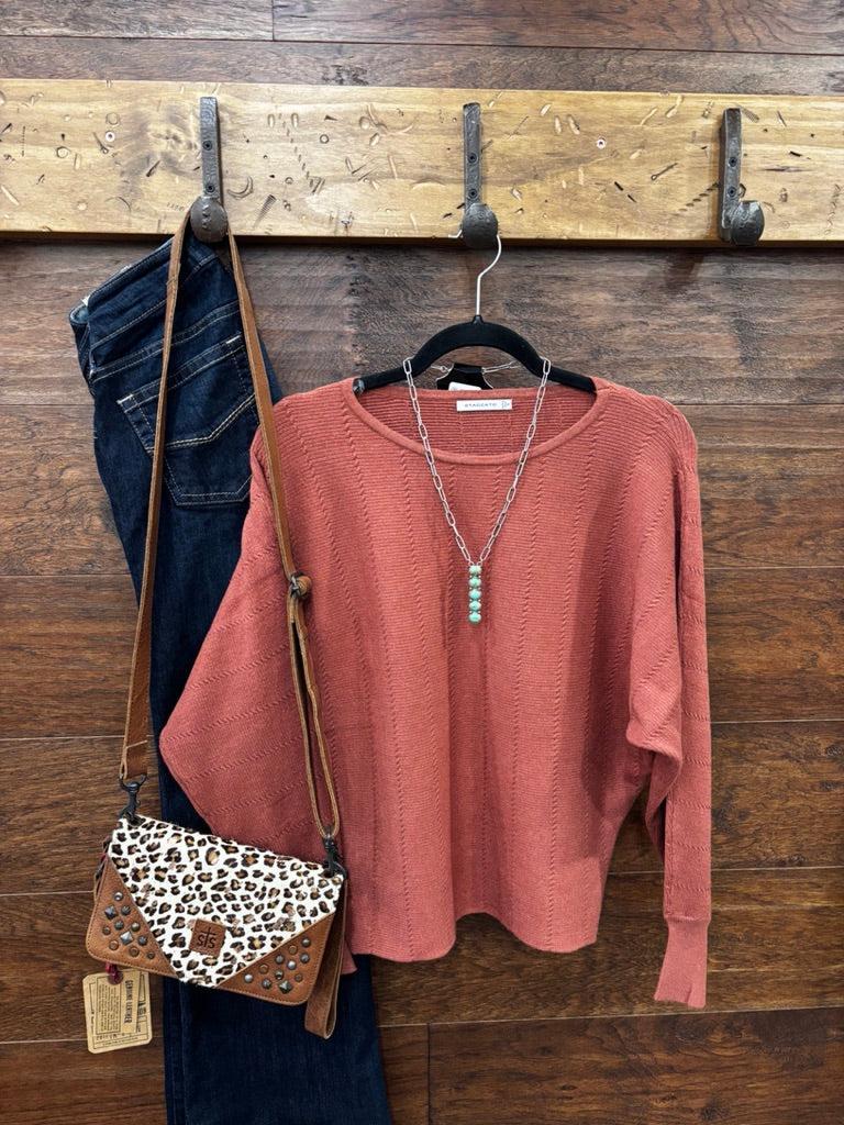 This sweater features a refined vertical texture, long dolman sleeves, and a classic boat neckline 