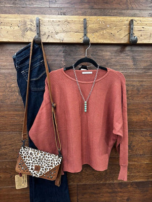 This sweater features a refined vertical texture, long dolman sleeves, and a classic boat neckline 