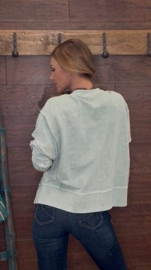 Woman wearing a mint green sweater 