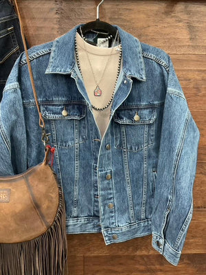 A blue denim jacket with a large embroidered steer skull design on the back. 