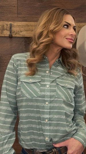 Woman wearing a green striped shirt with a wooden background