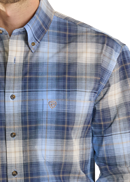 Close-up of a person wearing a blue and white plaid shirt with a collar.
