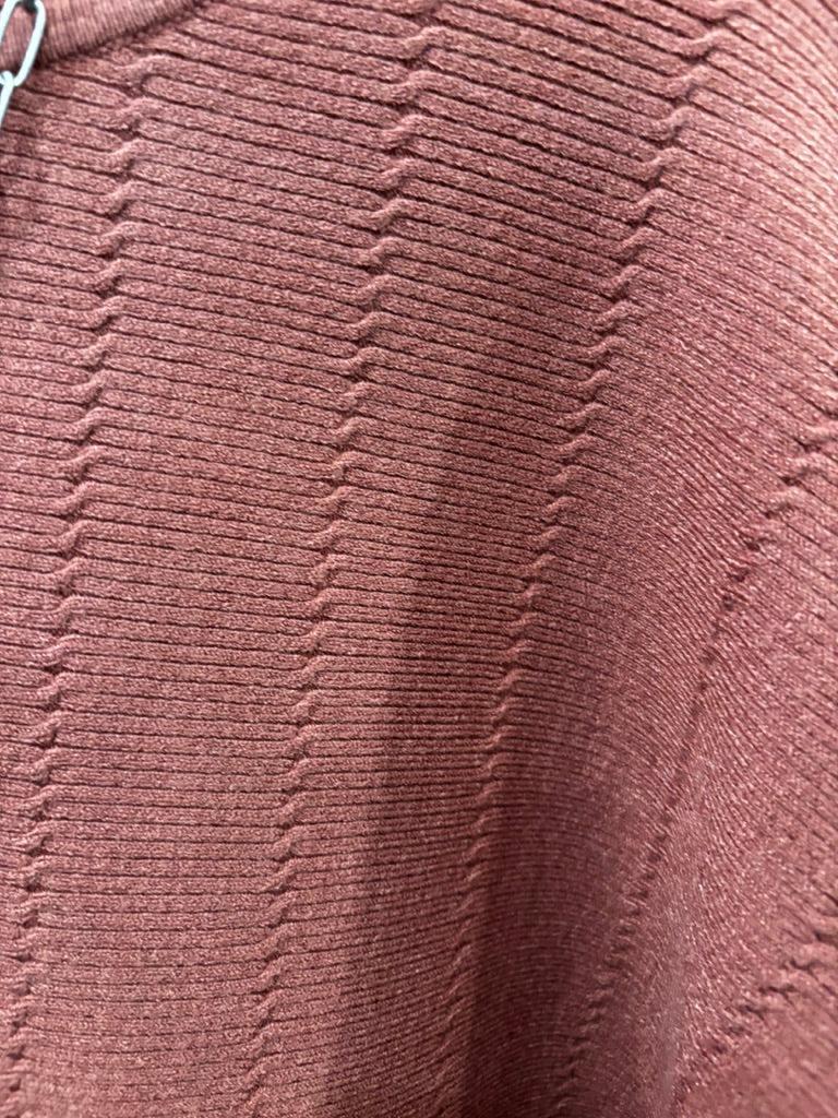 This sweater features a refined vertical texture, long dolman sleeves, and a classic boat neckline 