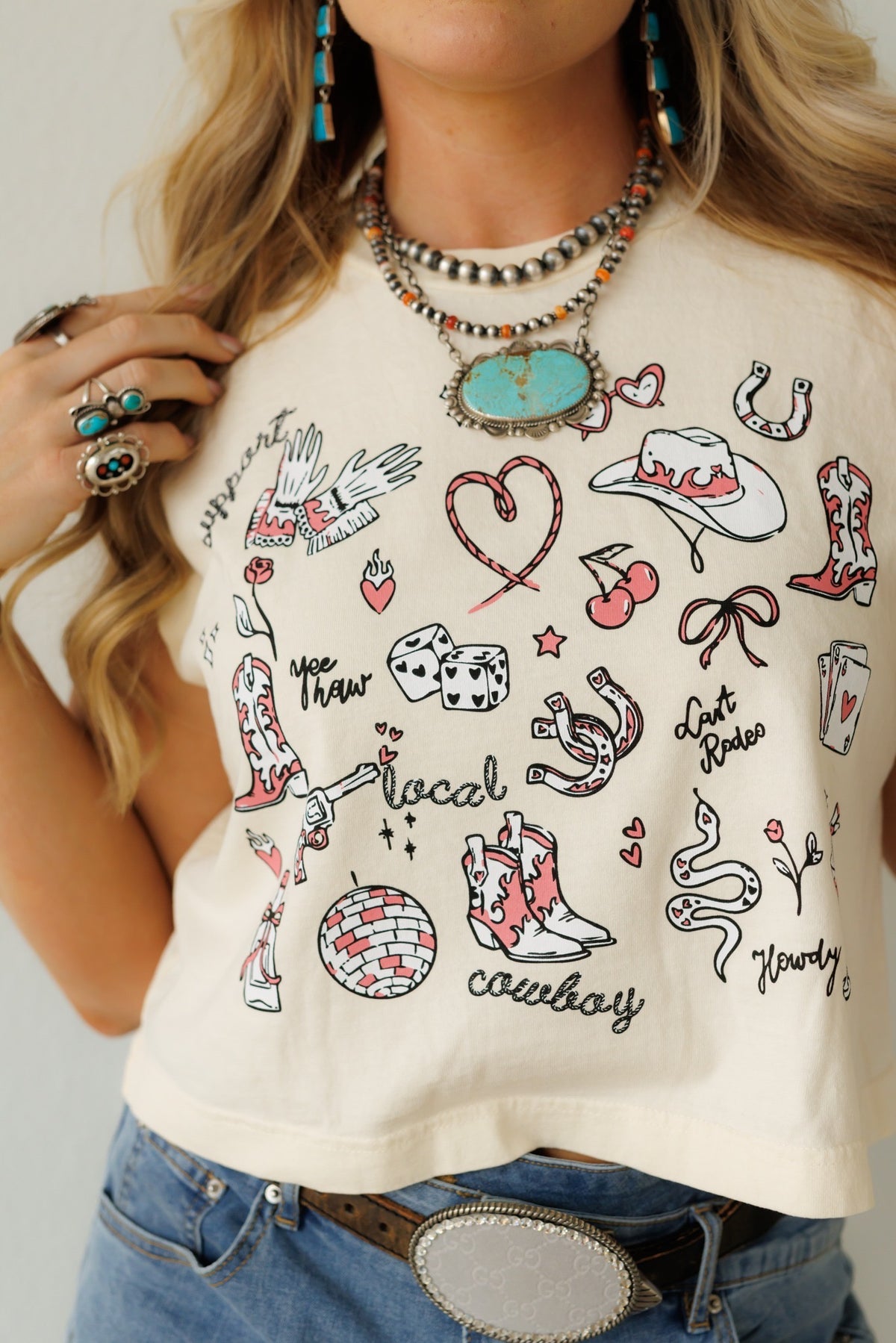 This white t-shirt features eye-catching cowboy graphics, perfect for adding Western flair. The soft fabric makes it ideal for everyday wear, and the bold design ensures you stand out. Pair it with jeans and boots for a complete look.