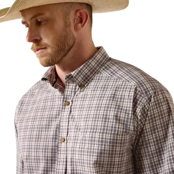 Man wearing a plaid shirt and cowboy hat on a white background