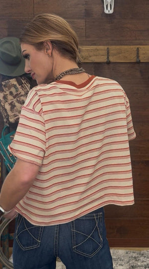 Woman wearing a striped shirt and jeans in a kitchen setting