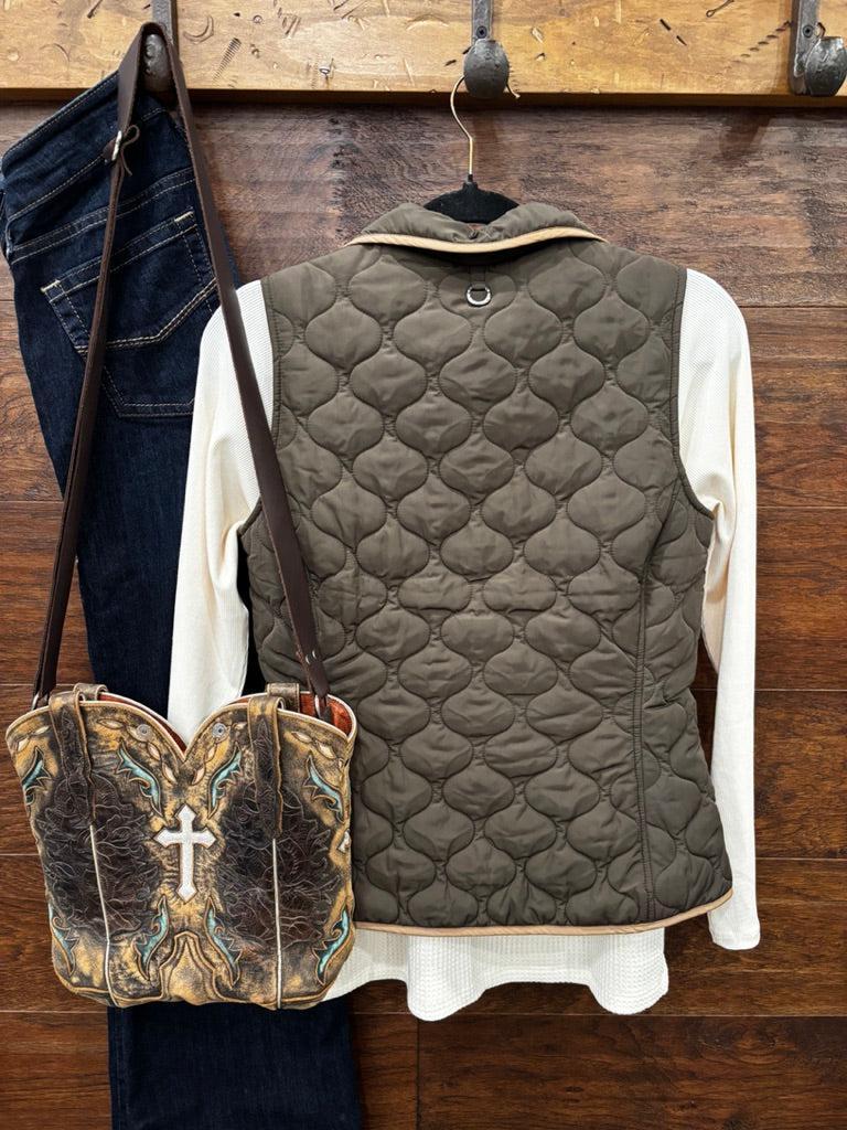 An earth tome quilted zip-up vest layered over a cream knit sweater