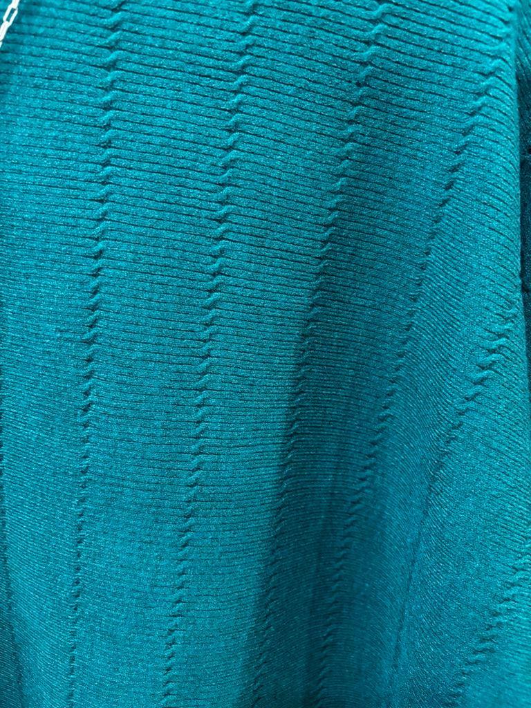 This sweater features a refined vertical texture, long dolman sleeves, and a classic boat neckline 