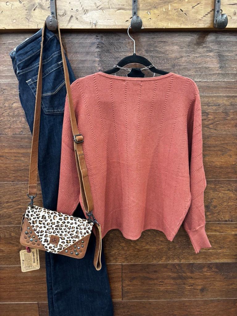This sweater features a refined vertical texture, long dolman sleeves, and a classic boat neckline 