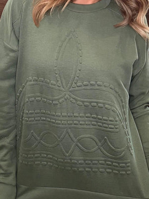 An olive green crewneck sweatshirt featuring a raised, textured geometric pattern across the front, shown on a model.