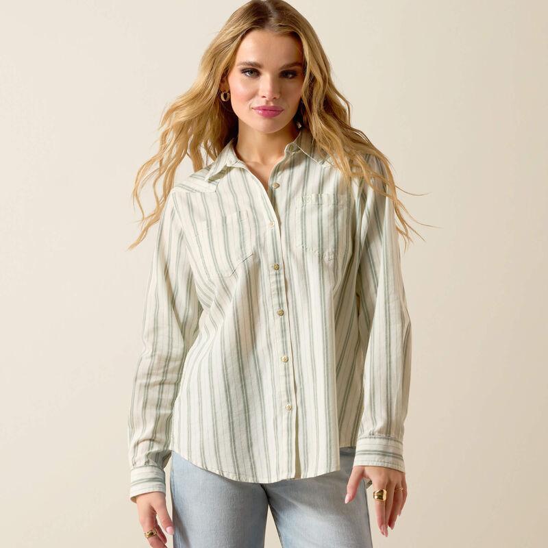 Woman wearing a striped shirt against a plain background