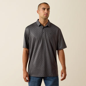Man wearing a gray patterned polo shirt against a beige background