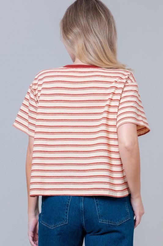 Woman wearing a striped t-shirt with small graphic designs 