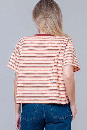 Woman wearing a striped t-shirt with small graphic designs 