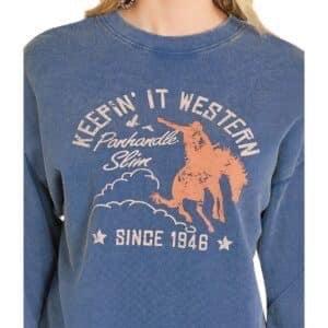 This cozy, blue crewneck sweatshirt features a bold, screen-printed graphic on the front that proudly displays "KEEPIN' IT WESTERN".