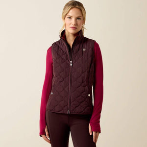A woman modeling a dark plum quilted zip-front vest 