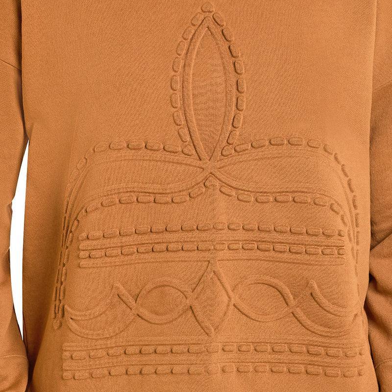 Close-up of a camel brown knit sweater featuring a raised, textured geometric and floral pattern on the front.