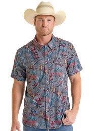 Man wearing a patterned shirt and cowboy hat in an outdoor setting