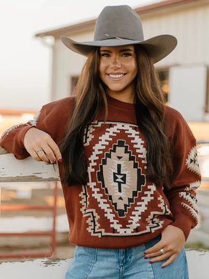 Woman wearing an Aztec patterned sweater. 