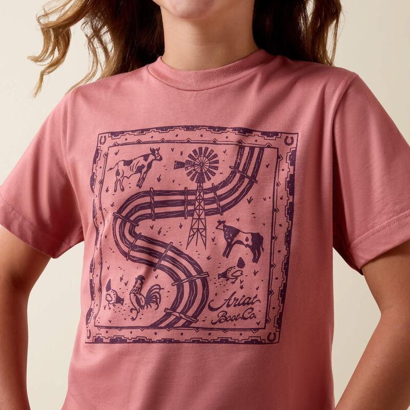 Person wearing a pink t-shirt with a purple graphic design on a beige background