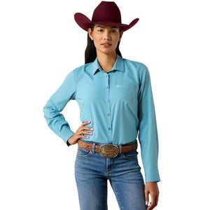 A woman modeling a light blue long-sleeve western button-up shirt  