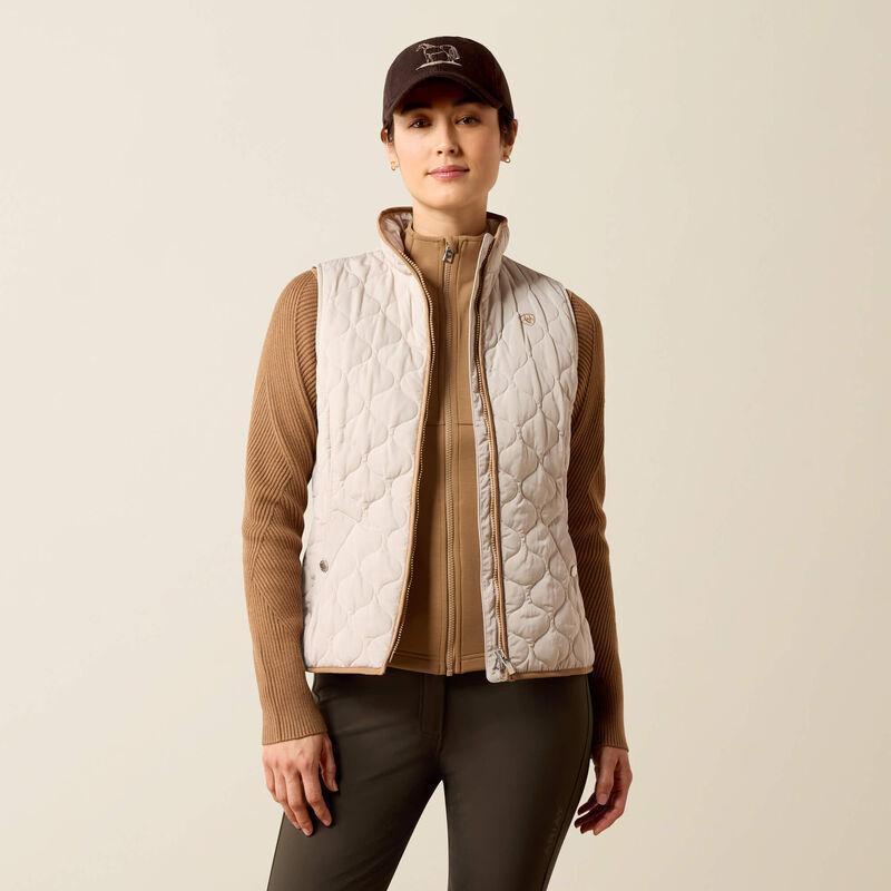 A woman modeling a quilted sleeveless vest 