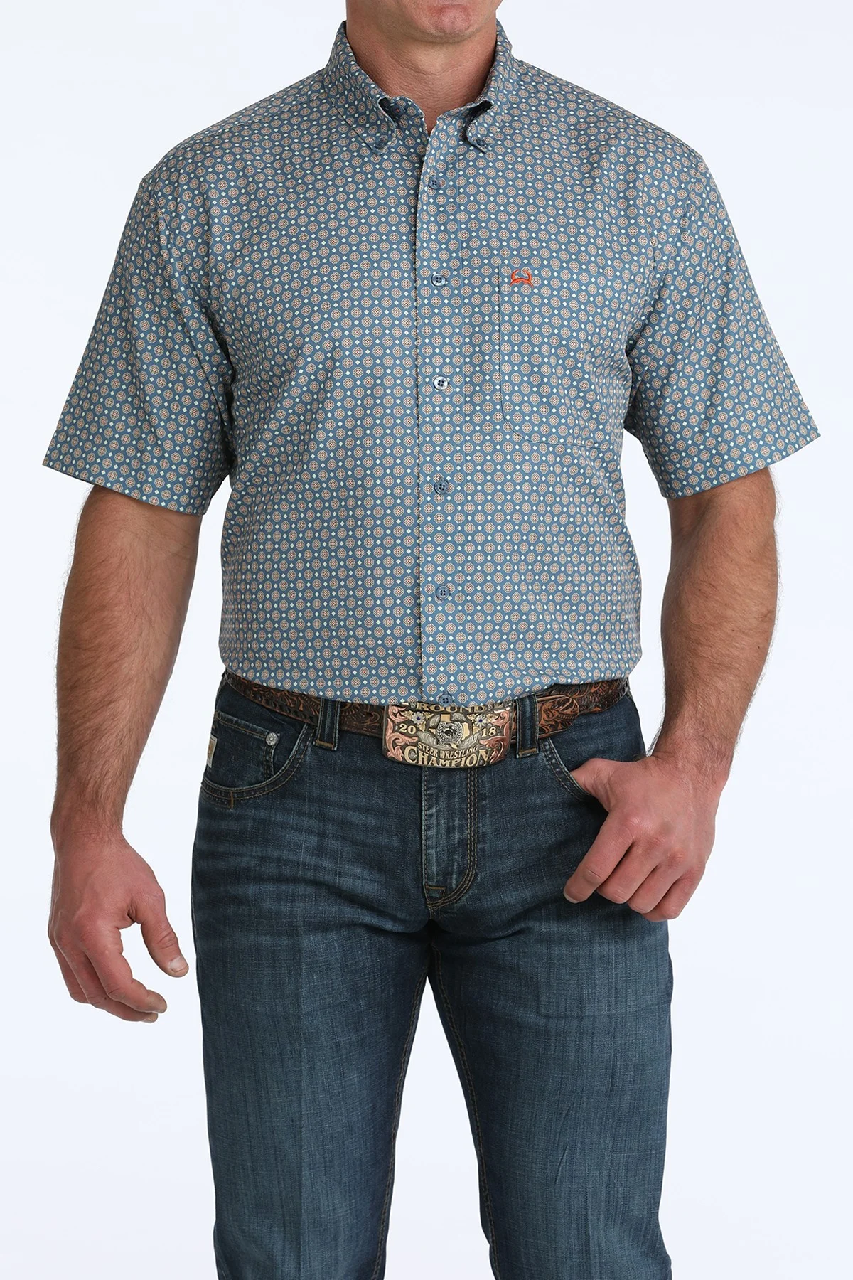 Man wearing a patterned short-sleeve shirt and jeans on a white background