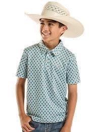 Child wearing a patterned shirt and cowboy hat