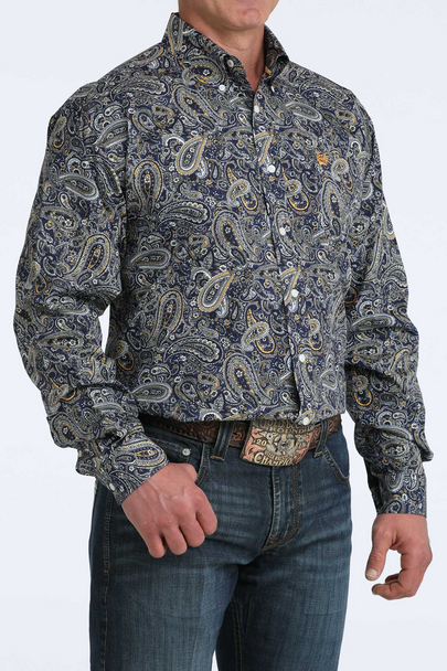 Man wearing a patterned shirt and jeans on a white background
