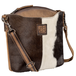 Brown and white cowhide leather bag with a visible brand logo on a white background