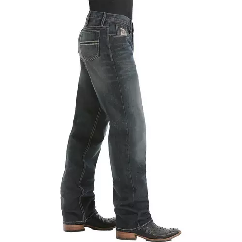 Dark blue jeans worn by a person on a white background