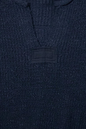 Navy blue textured fabric with a brand label