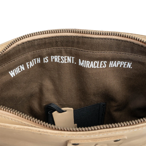 Brown bag with motivational text 'When faith is present, miracles happen.'