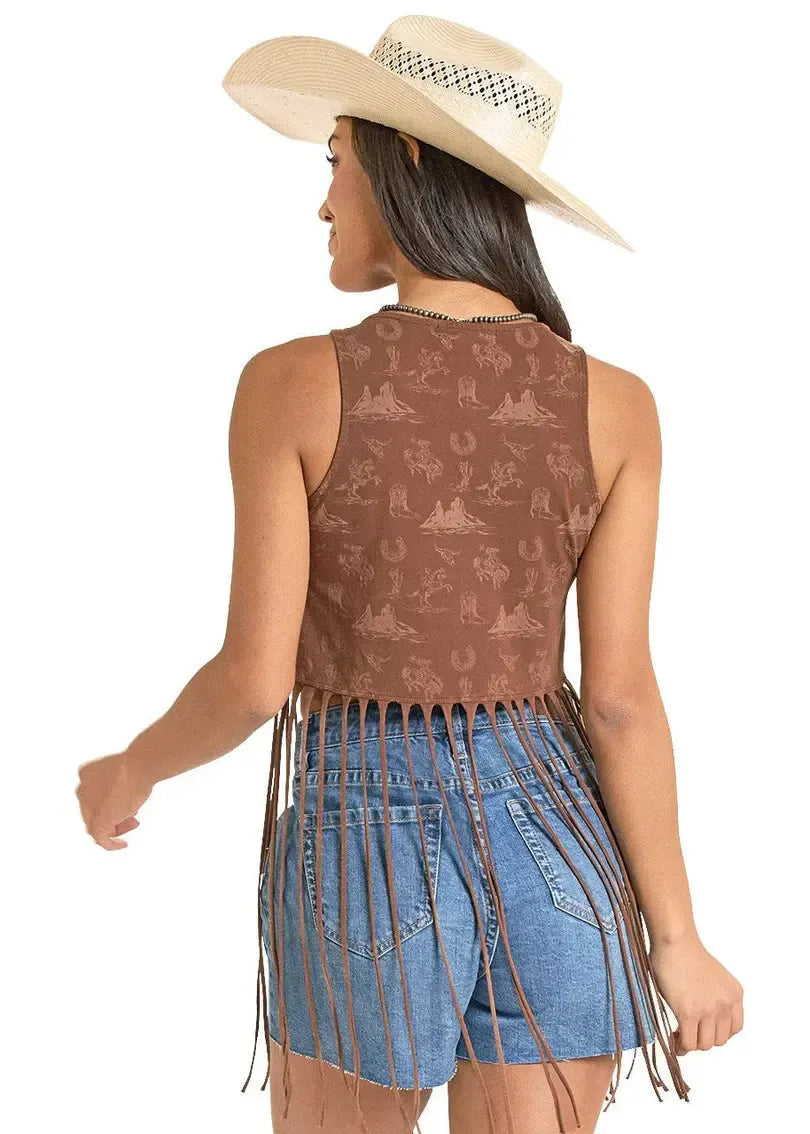 Woman wearing a brown patterned tank top with fringes and a blue denim skirt, paired with a beige cowboy hat on a white background.