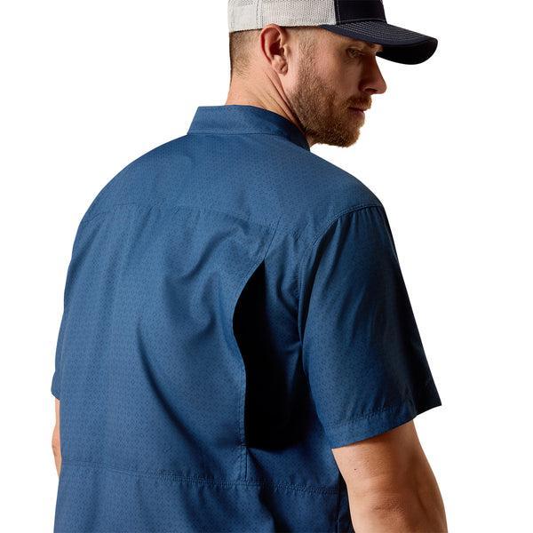 Man wearing a blue shirt and cap on a white background