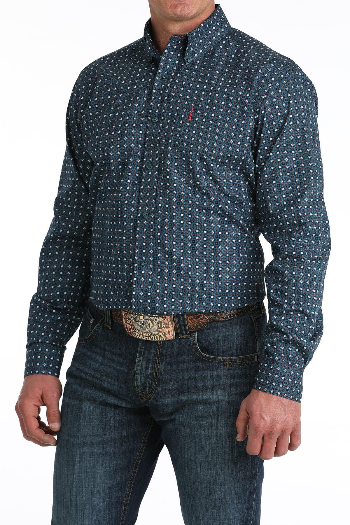 Man wearing a blue patterned shirt and jeans on a white background