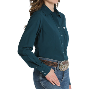 Teal long-sleeve shirt worn by a person on a white background