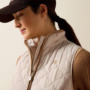 A woman modeling a quilted sleeveless vest 