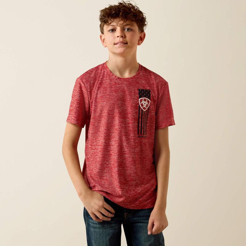 Young boy wearing a red t-shirt with a graphic design on a beige background